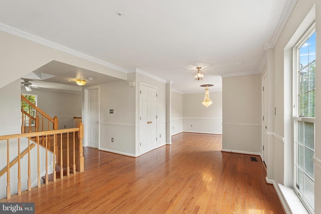 6814 Springshire Way, Greenbelt, MD 20770 - spare room with wood finished floors, ornamental molding, baseboards, stairs, and a pendent fire sprinkler
