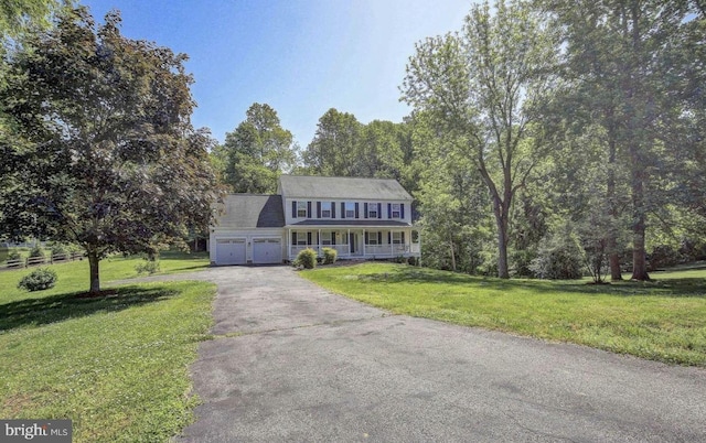 3245 Loring Dr, Huntingtown, MD 20639 - colonial inspired home with covered porch, a garage, asphalt driveway, and a front yard