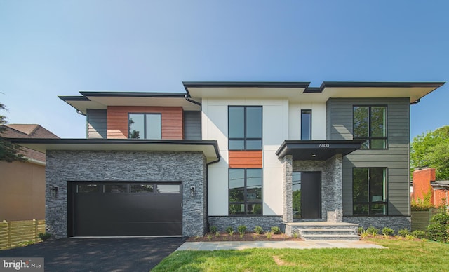 6800 Old Chesterbrook Rd, Mclean, VA 22101 - contemporary home with stone siding, an attached garage, and driveway