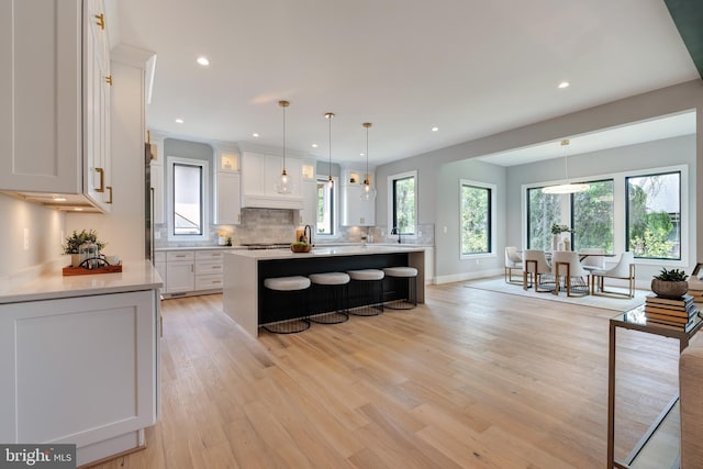 6800 Old Chesterbrook Rd, Mclean, VA 22101 - kitchen with light countertops, white cabinets, decorative backsplash, light wood-style floors, and recessed lighting