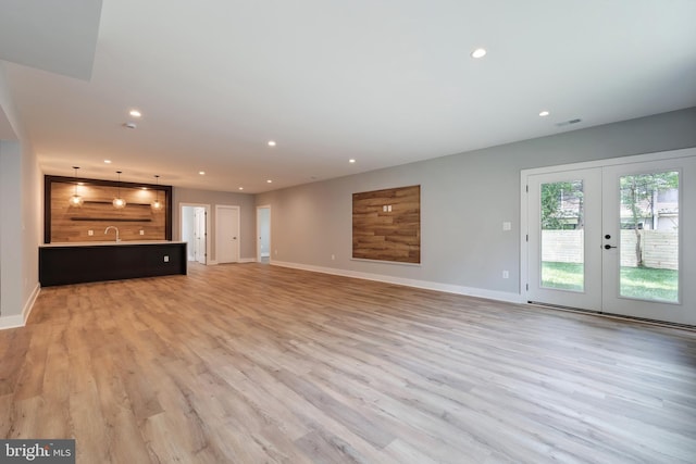 6800 Old Chesterbrook Rd, Mclean, VA 22101 - unfurnished living room with baseboards, recessed lighting, light wood-style floors, french doors, and a sink
