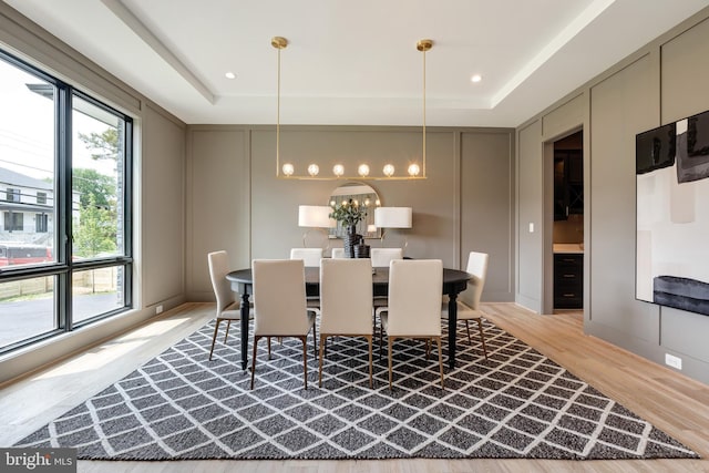 6800 Old Chesterbrook Rd, Mclean, VA 22101 - dining room featuring a raised ceiling, a decorative wall, light wood-style flooring, and a chandelier