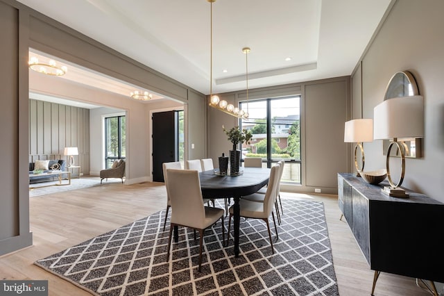 6800 Old Chesterbrook Rd, Mclean, VA 22101 - dining space with a chandelier, light wood finished floors, a tray ceiling, and baseboards
