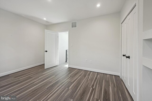 1850 Ingleside Ter NW Unit 2, Washington, DC 20010 - unfurnished bedroom with recessed lighting, dark wood-type flooring, baseboards, and a closet