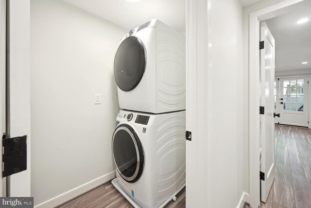 1850 Ingleside Ter NW Unit 2, Washington, DC 20010 - laundry area featuring stacked washer / dryer, wood finished floors, baseboards, and recessed lighting