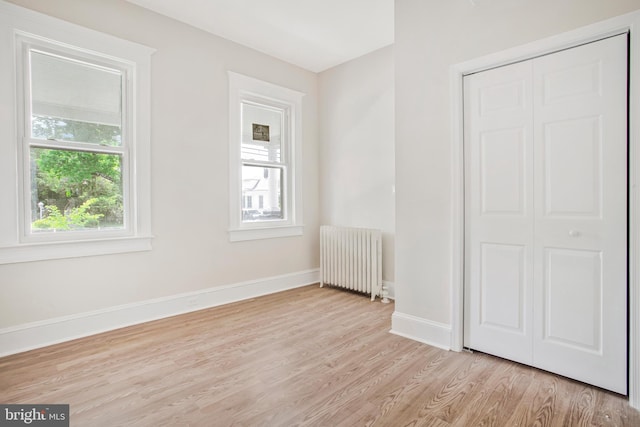 1003 Walnut Ave, Baltimore, MD 21229 - unfurnished room featuring radiator heating unit, wood finished floors, and baseboards