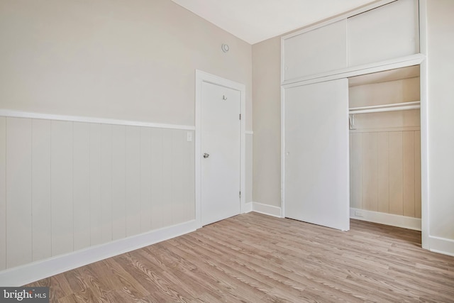 1003 Walnut Ave, Baltimore, MD 21229 - unfurnished bedroom with wood finished floors, a closet, and baseboards