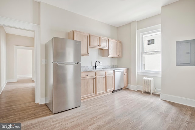 1003 Walnut Ave, Baltimore, MD 21229 - kitchen with stainless steel appliances, electric panel, radiator, and light brown cabinets