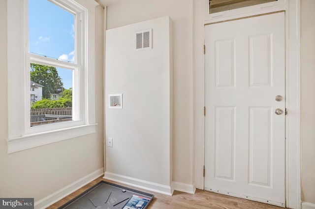 1003 Walnut Ave, Baltimore, MD 21229 - doorway to outside with baseboards and light wood finished floors