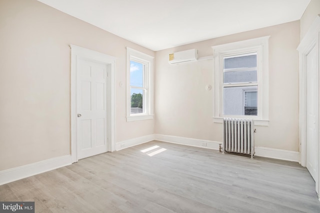 1003 Walnut Ave, Baltimore, MD 21229 - empty room featuring radiator, a wall unit AC, wood finished floors, and baseboards