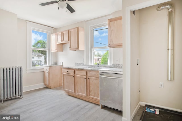 1003 Walnut Ave, Baltimore, MD 21229 - kitchen with radiator heating unit, stainless steel dishwasher, light brown cabinets, a sink, and a ceiling fan