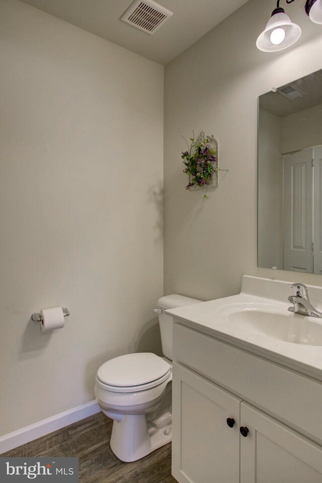 605 Byler Cir, Lebanon, PA 17042 - half bath featuring vanity, toilet, wood finished floors, and baseboards