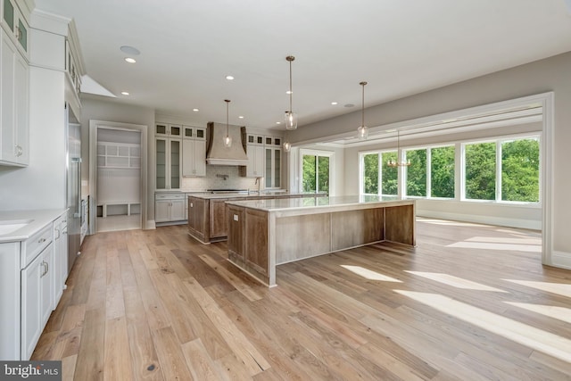 545 Webb Rd # Dd, Chadds Ford, PA 19317 - kitchen with custom exhaust hood, a large island, light wood finished floors, healthy amount of natural light, and recessed lighting