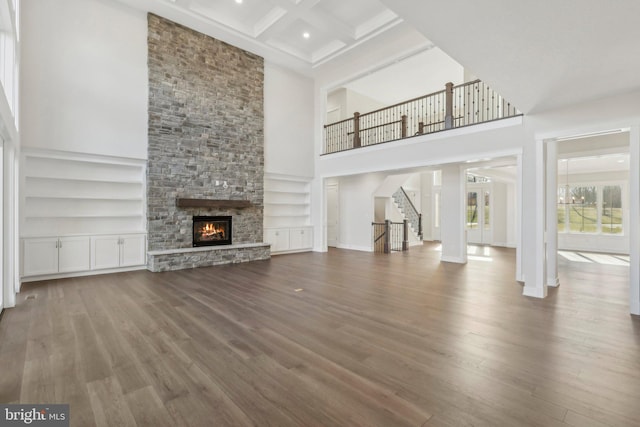 545 Webb Rd # Dd, Chadds Ford, PA 19317 - unfurnished living room featuring a high ceiling, built in features, wood finished floors, a fireplace, and beam ceiling