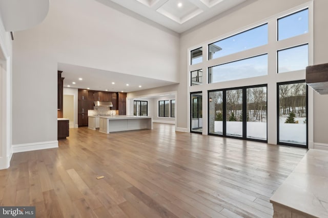 545 Webb Rd # Dd, Chadds Ford, PA 19317 - unfurnished living room featuring a high ceiling, light wood-type flooring, beamed ceiling, coffered ceiling, and recessed lighting