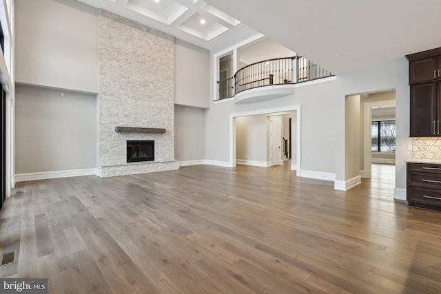 545 Webb Rd # Dd, Chadds Ford, PA 19317 - unfurnished living room featuring a fireplace, a high ceiling, coffered ceiling, wood finished floors, and beam ceiling