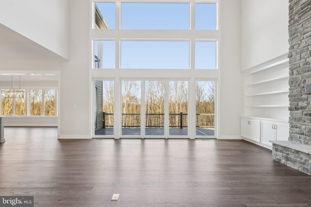 545 Webb Rd # Dd, Chadds Ford, PA 19317 - unfurnished living room featuring a high ceiling, dark wood-style flooring, baseboards, and a chandelier