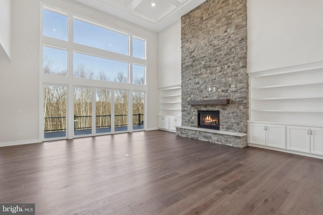 545 Webb Rd # Dd, Chadds Ford, PA 19317 - unfurnished living room featuring a towering ceiling, wood finished floors, a fireplace, built in features, and baseboards