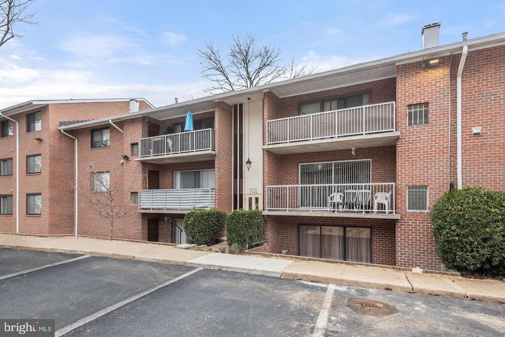 203 Cork Ln Unit 103, Reisterstown, MD 21136 - view of apartment building / complex featuring uncovered parking