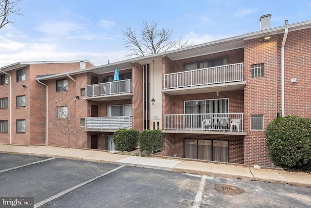 203 Cork Ln Unit 103, Reisterstown, MD 21136 - view of apartment building / complex featuring uncovered parking