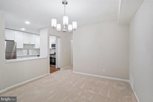 203 Cork Ln Unit 103, Reisterstown, MD 21136 - unfurnished dining area with a chandelier, light colored carpet, and recessed lighting