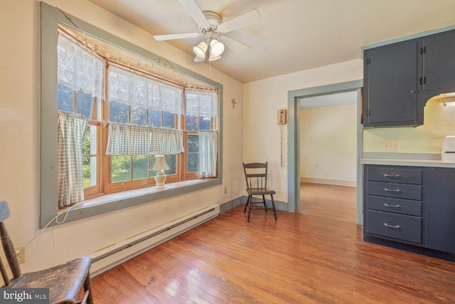 404 Clear Ridge Rd, Union Bridge, MD 21791 - kitchen with wood finished floors, a ceiling fan, a baseboard radiator, baseboards, and light countertops