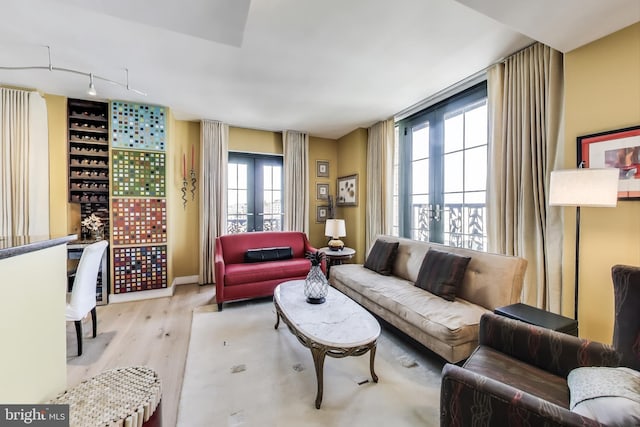910 M St NW Unit 1022, Washington, DC 20001 - living area featuring healthy amount of natural light, wood finished floors, french doors, and track lighting