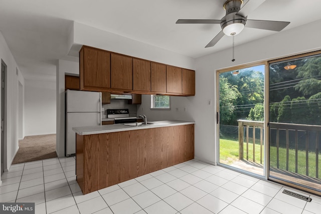 1040 Muscovy Ln, Bensalem, PA 19020 - kitchen featuring freestanding refrigerator, range with electric stovetop, a peninsula, a sink, and under cabinet range hood