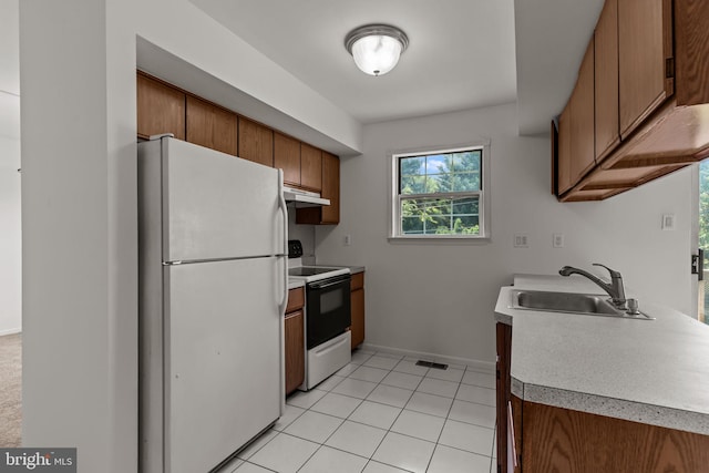 1040 Muscovy Ln, Bensalem, PA 19020 - kitchen with freestanding refrigerator, electric stove, a sink, under cabinet range hood, and brown cabinetry
