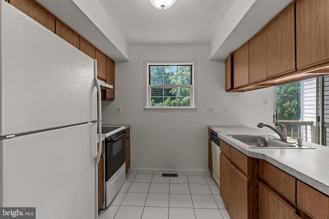 1040 Muscovy Ln, Bensalem, PA 19020 - kitchen featuring white appliances, a sink, under cabinet range hood, and healthy amount of natural light