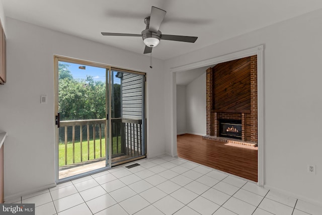 1040 Muscovy Ln, Bensalem, PA 19020 - unfurnished living room with a ceiling fan, a brick fireplace, light tile patterned floors, and baseboards