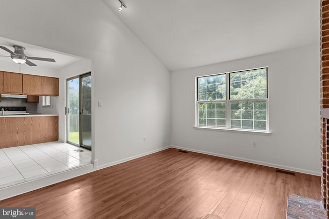 1040 Muscovy Ln, Bensalem, PA 19020 - unfurnished living room featuring healthy amount of natural light, light wood-type flooring, a ceiling fan, lofted ceiling, and baseboards