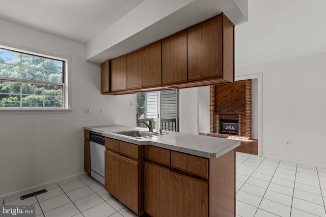 1040 Muscovy Ln, Bensalem, PA 19020 - kitchen with dishwashing machine, a sink, a peninsula, light tile patterned floors, and healthy amount of natural light