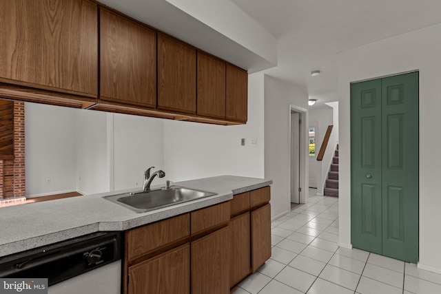 1040 Muscovy Ln, Bensalem, PA 19020 - kitchen featuring dishwasher, a sink, light tile patterned flooring, light countertops, and baseboards