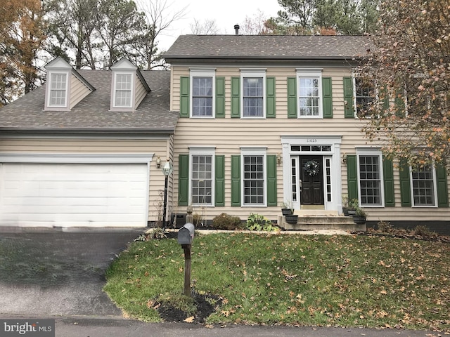 11025 Gaither Hunt Ln, Columbia, MD 21044 - colonial home featuring an attached garage, a shingled roof, and a front lawn