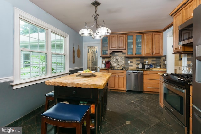 50 Skillman Rd, Skillman, NJ 08558 - kitchen with appliances with stainless steel finishes, wood counters, a chandelier, tasteful backsplash, and brown cabinetry