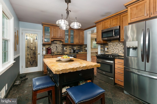 50 Skillman Rd, Skillman, NJ 08558 - kitchen with stainless steel appliances, brown cabinetry, decorative backsplash, and glass insert cabinets