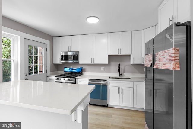 2723 Keating St, Temple Hills, MD 20748 - kitchen featuring appliances with stainless steel finishes, a sink, light countertops, and white cabinets