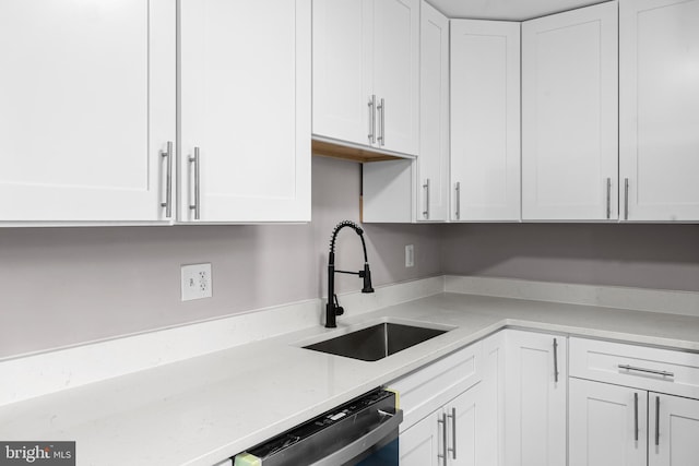 2723 Keating St, Temple Hills, MD 20748 - kitchen featuring a sink, dishwasher, white cabinetry, and light stone counters