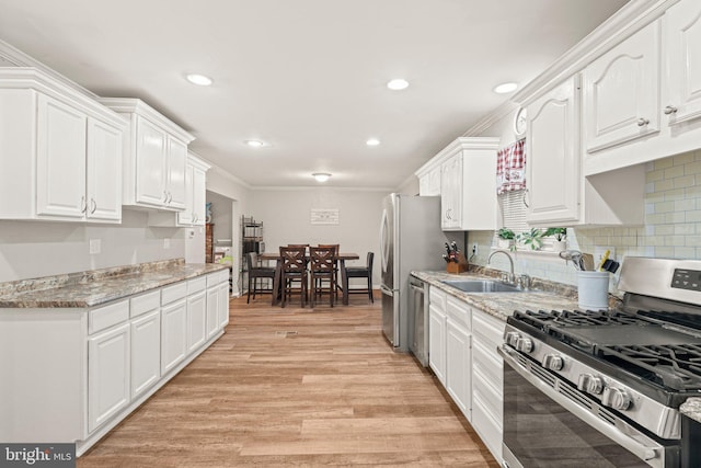 34 Swarthmore Ave, Stratford, NJ 08084 - kitchen with appliances with stainless steel finishes, white cabinetry, light wood-style flooring, recessed lighting, and light stone countertops