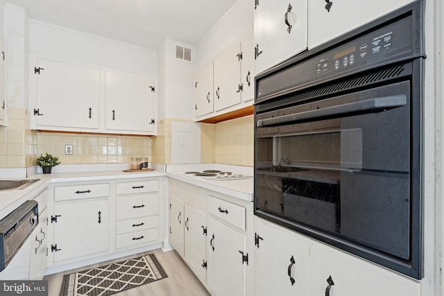1900 John F Kennedy Blvd Unit 924, Philadelphia, PA 19103 - kitchen featuring oven, dishwasher, white cabinetry, tasteful backsplash, and light countertops