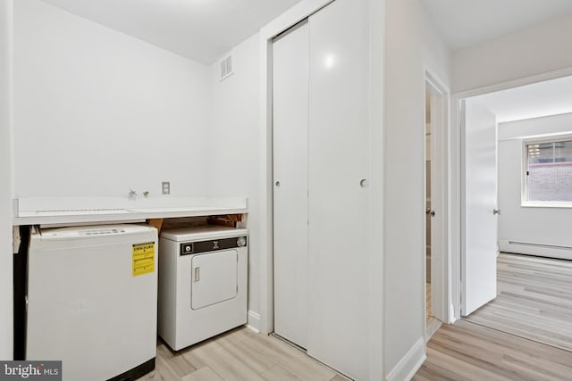 1900 John F Kennedy Blvd Unit 924, Philadelphia, PA 19103 - laundry room featuring light wood finished floors, baseboard heating, and washer and clothes dryer