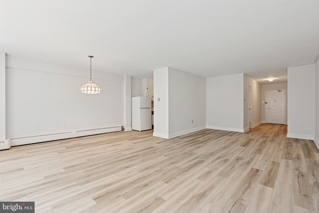 1900 John F Kennedy Blvd Unit 924, Philadelphia, PA 19103 - unfurnished living room featuring a baseboard heating unit, light wood finished floors, and a chandelier