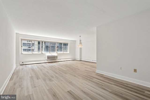 1900 John F Kennedy Blvd Unit 924, Philadelphia, PA 19103 - unfurnished living room with wood finished floors, a wall mounted air conditioner, and a baseboard heating unit