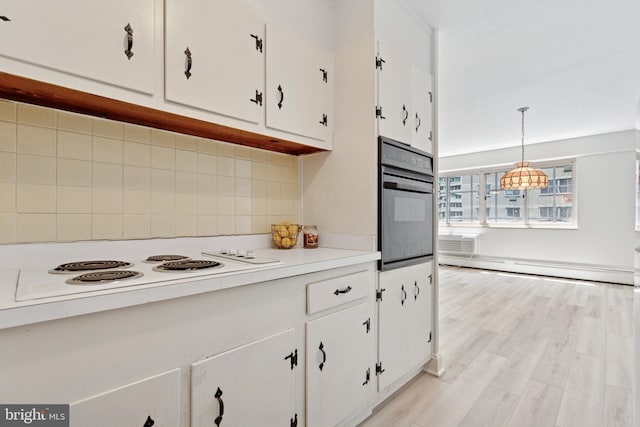 1900 John F Kennedy Blvd Unit 924, Philadelphia, PA 19103 - kitchen featuring black oven, white cabinets, tasteful backsplash, white electric cooktop, and light countertops