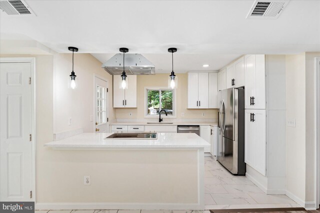 12820 Maple St, Silver Spring, MD 20904 - kitchen featuring appliances with stainless steel finishes, baseboards, light marble finish floors, a peninsula, and a sink