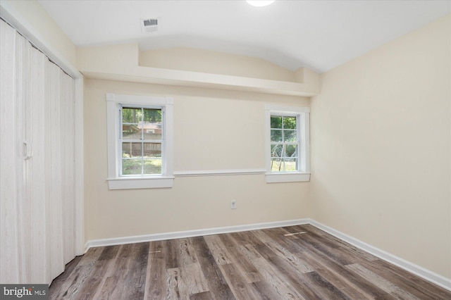 12820 Maple St, Silver Spring, MD 20904 - unfurnished bedroom featuring multiple windows, lofted ceiling, wood finished floors, and a closet