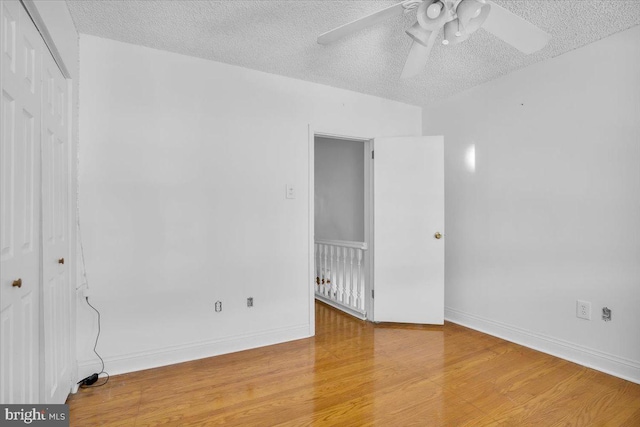 2637 S Bouvier St, Philadelphia, PA 19145 - empty room with ceiling fan, a textured ceiling, light wood finished floors, and baseboards