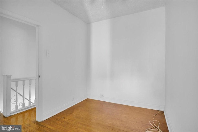2637 S Bouvier St, Philadelphia, PA 19145 - empty room with a textured ceiling, wood finished floors, and baseboards