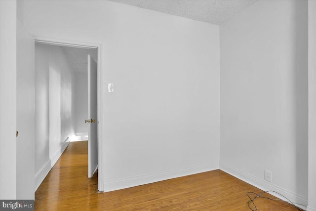 2637 S Bouvier St, Philadelphia, PA 19145 - empty room featuring wood finished floors, baseboards, and a textured ceiling